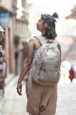 A woman wearing natural hemp color backpack